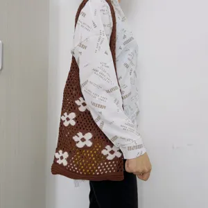 Brown crochet tote bag with white flower pattern, hollow knit shoulder bag for women daily use.