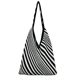 Vista dettagliata della borsa tote in maglia con motivo a righe nero e bianco e tessuto morbido.