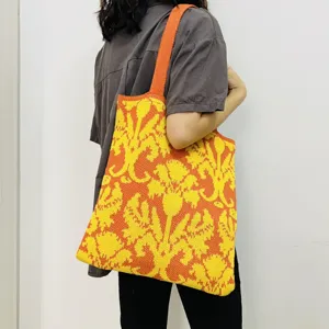 Gestrickte Blumen-Tasche für Damen, retro lässige Schultertasche mit orangem gelbem Muster.