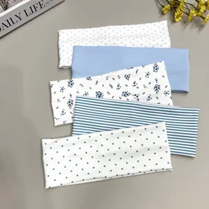 Close-up of assorted floral striped polka dot stretch headbands for yoga and daily sports.