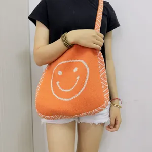Orangene Strick-Tragetasche mit niedlichem weißem Smiley-Muster, lässige Damen-Umhängetasche.
