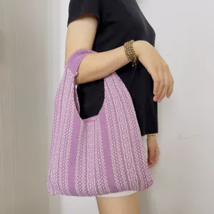 Detailed view of a purple knitted geometric pattern shoulder bag, perfect for casual underarm wear.