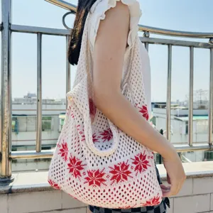 Gestrickte Netz-Tragetasche Schultertasche mit rotem Schneeflockenmuster im Detail.