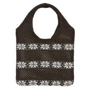 Detail der braunen Stricktasche mit filigranem Schneeflockenmuster und offener Netzstruktur.