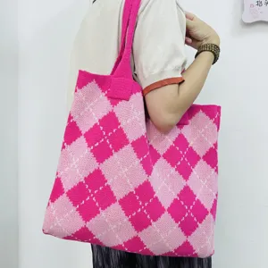 Detailed view of the pink argyle knitted tote bag, showing its large capacity and soft texture.