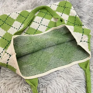Detailed view of the green and white argyle knit tote bag interior and fabric texture.
