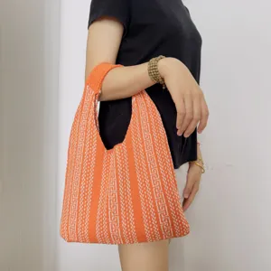 Orange knit shoulder bag featuring unique geometric pattern detail for casual daily use.