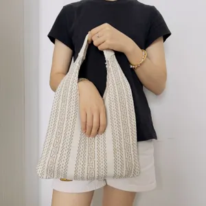 Knitted hobo shoulder bag with geometric pattern, casual soft tote for daily use and travel.