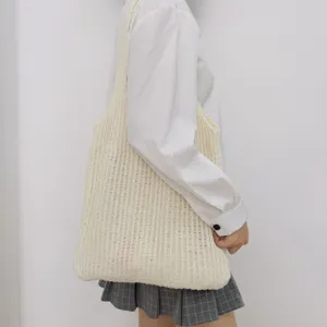 Beige gestrickte Tragetasche für Damen, große lässige Umhängetasche getragen vom Model.