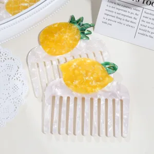 Cute fruit acetate hair comb detail shot, featuring pineapple and lemon designs with wide teeth.