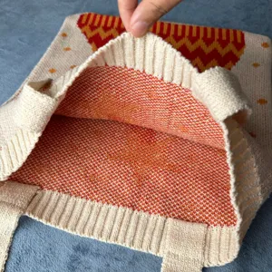 Stricktasche Detailaufnahme des Innenraums mit feiner Textur und farbigem Muster Design.