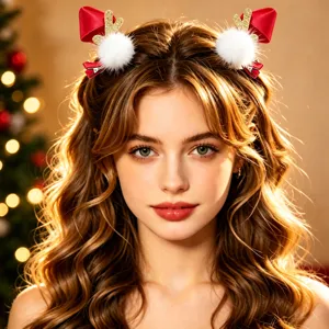 Close-up detail of Christmas deer antler hair clips with red velvet bow and white pom-poms.