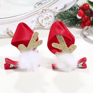 Christmas reindeer antler hair clip detail featuring soft velvet red hat and fluffy white pom.