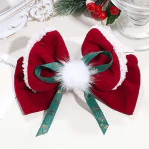 Close-up detail shot of Christmas velvet hair bow clip with faux fur and snowflake ribbon.