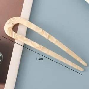 Acetate U-shaped hair fork detail view, minimalist tortoiseshell hair accessory for elegant buns.