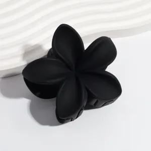 Black matte plumeria flower hair claw clip, chic minimalist non-slip hair styling accessory.