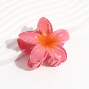 Detailed close-up of a pink jelly-color plumeria flower hair claw clip, translucent resin texture.