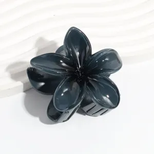 Dark grey plumeria flower hair claw clip detail close-up showcasing jelly texture.