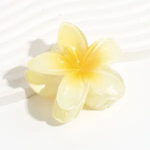 Translucent yellow plumeria flower hair claw clip, jelly style floral hair accessory summer.