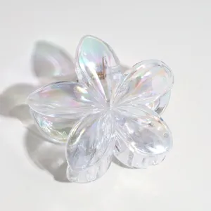 Close-up detail shot of transparent iridescent flower hair claw clip, gorgeous pearl shine.