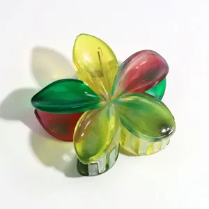 Colorful jelly plumeria hair claw clip, vibrant floral design hair accessory for summer styling.
