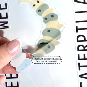 Close-up detail of cartoon insect wall sticker showing adhesive backing and peel process.