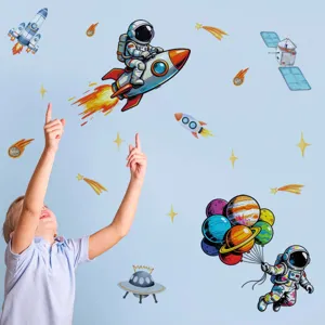 Detailed view of kids space wall stickers featuring astronauts, planets, and rockets on a blue wall.