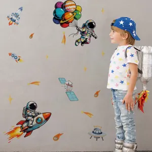 Children room space wall sticker set with cute astronaut and glowing planets for bedroom decor.