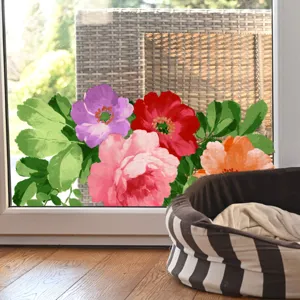 Detail view of colorful floral static window sticker applied on glass inside a cozy home setup.