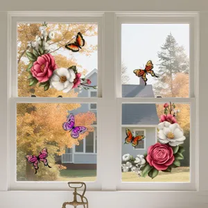 Detail shot showing colorful floral and butterfly window stickers applied on glass surface.