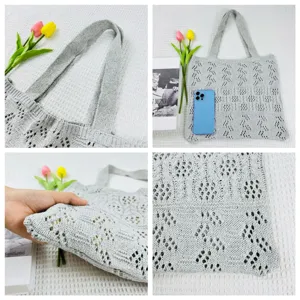 Detailansicht der grauen Strick-Shopper-Tasche mit feinem Lochmuster, Henkel und Textur.