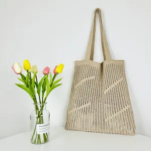Beige knitted hollow shoulder tote bag, casual large capacity beach bag for daily use.