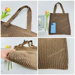 Detailed view of the brown knitted hollow tote bag, showing strap and mesh texture.