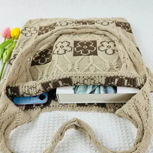 Knit tote bag detail view, featuring retro floral pattern, spacious interior and style.