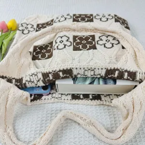 Detailed view of the knitted tote bag featuring charming brown floral grid patterns.