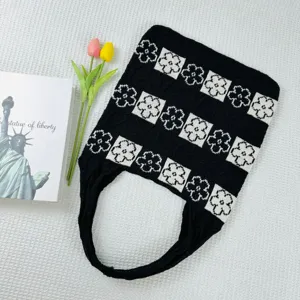 Chic black and white knitted tote bag with floral pattern, large capacity casual woven shoulder bag.