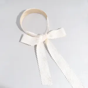 Primer plano de una diadema de cinta de encaje estilo coreano con un diseño de lazo delicado.