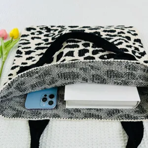 Detailansicht der schwarz-weißen Leoparden Stricktasche mit geräumigem Innenraum und Requisiten.