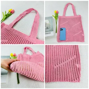 Pink knit hollow out tote bag detail view, showing mesh weave texture, straps and capacity.