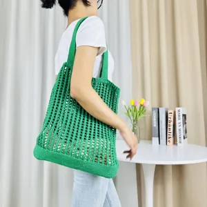 Grüne gestrickte hohle Umhängetasche, lässige Strandtasche mit detaillierter Textur und Passform.