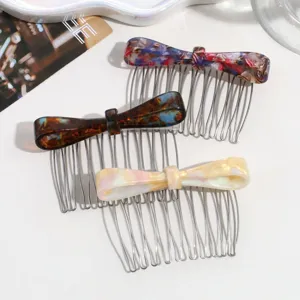 Close-up detail of acetate bow hair combs with metal teeth, stylish hair accessories for women.