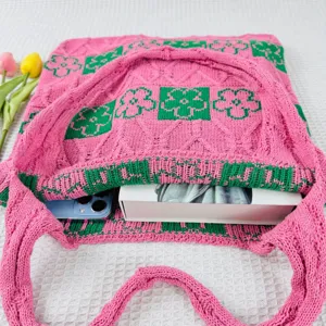 Pink and green floral knit tote bag detail, featuring casual woven texture and spacious casual style.