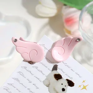 Mini pink angel wings hair claw with sparkling rhinestones, perfect for sweet cute styling.