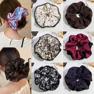 Oversized hair scrunchie detail shot, elegant floral and leopard print hair ties for women and girls styling.