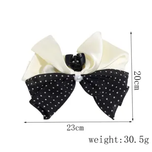 Double bow hair claw clip featuring black polka dot chiffon and off-white satin fabric.
