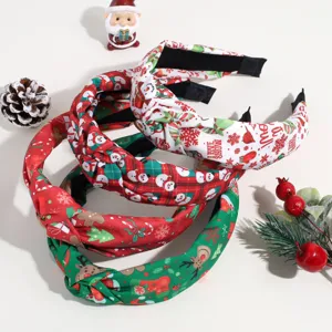 Christmas themed knotted headband detail, festive snowman and elk print fabric hoop close up.