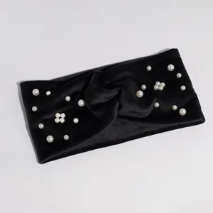 Velvet pearl headband detail view showing soft fabric and elegant white bead decoration.