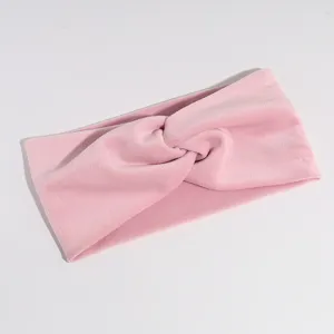 Pink velvet twisted headband detail view, soft stretch fabric hair accessory closeup