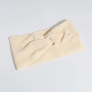 Detailed view of the solid beige velvet cross headband, soft stretch fabric for daily wear.