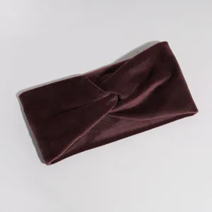 Close-up detail of the wine red velvet twisted headband texture and elastic fabric material.